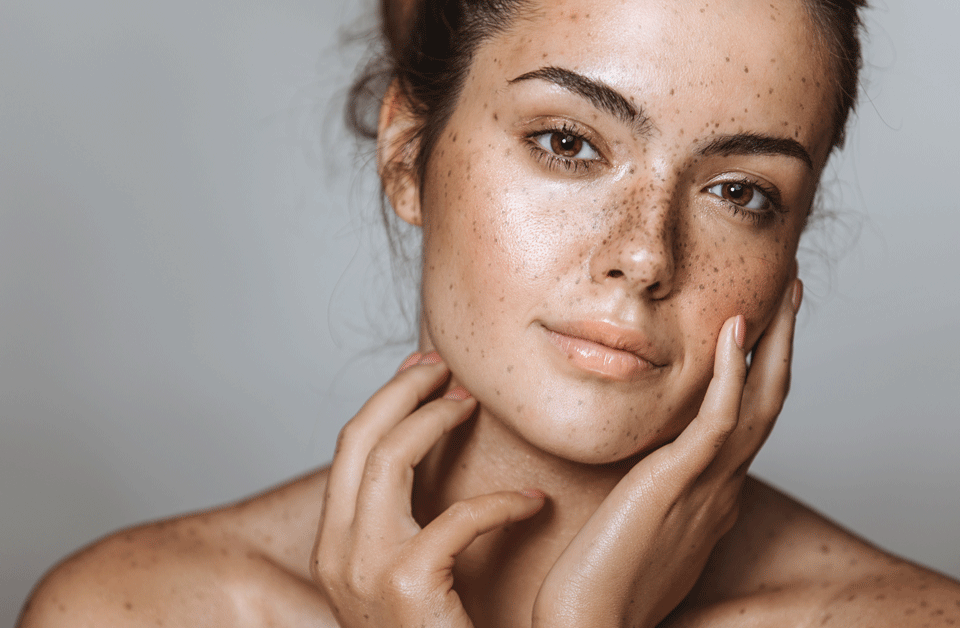 Attractive young woman with beautiful skin seen from bare shoulders up