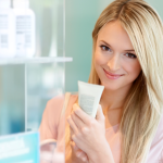 Beautiful woman looking at skincare products.