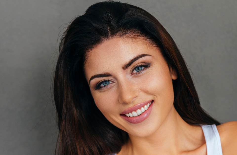 Woman from shoulders up smiling with head slightly tilted