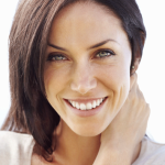 Head shot of attractive, smiling woman with short, brown hair