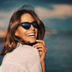 Woman in sunglasses looking back and smiling