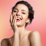 young woman with beautiful skin touching her face (model)